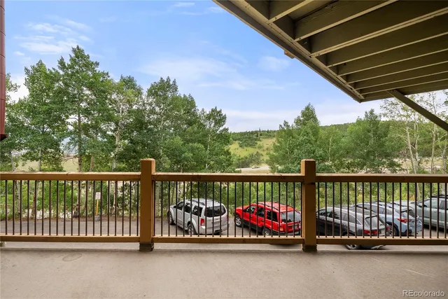 a view of roof deck with lawn chairs and wooden fence