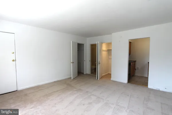 a view of an empty room and closet area