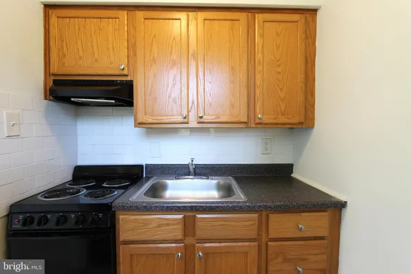 a kitchen with a stove and a sink