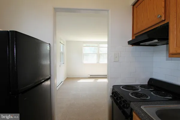 a kitchen with a refrigerator and a stove