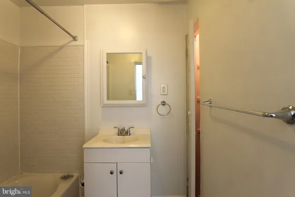 a bathroom with a sink and mirror