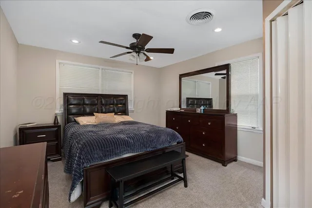 a bedroom with a bed and a mirror