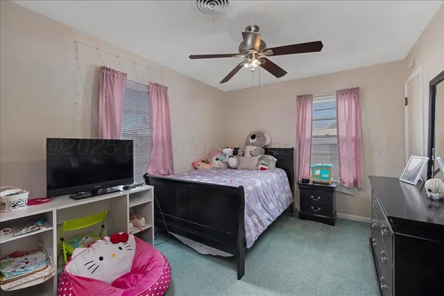 a bedroom with a bed and flat screen tv
