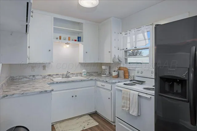 a kitchen with cabinets appliances and a counter space