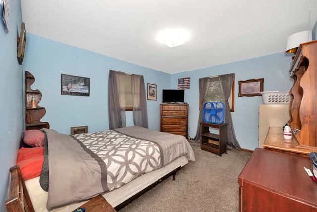 a bedroom with a bed and a tv on table