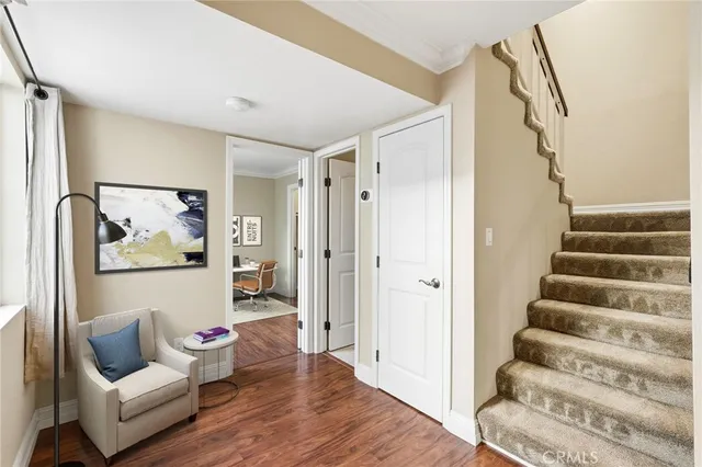 a view of a bedroom with furniture and wooden floor
