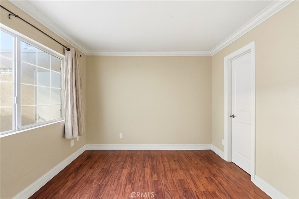 19208 Hamlin Street, Unit 5 Reseda, CA 91335 - Photo 13 of 31 a view of an empty room with wooden floor and a window