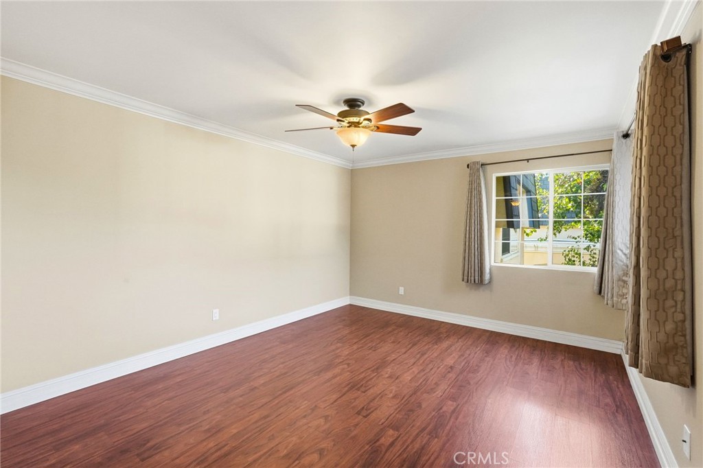 19208 Hamlin Street, Unit 5 Reseda, CA 91335 - Photo 16 of 31 an empty room with wooden floor and windows