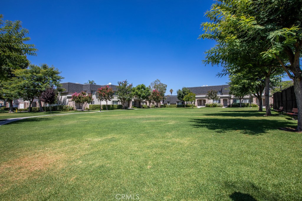 19208 Hamlin Street, Unit 5 Reseda, CA 91335 - Photo 28 of 31 a view of building with garden and trees in the background