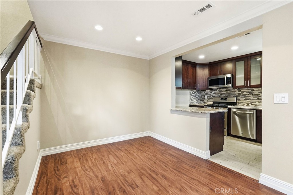 19208 Hamlin Street, Unit 5 Reseda, CA 91335 - Photo 9 of 31 a kitchen with a refrigerator and a stove top oven