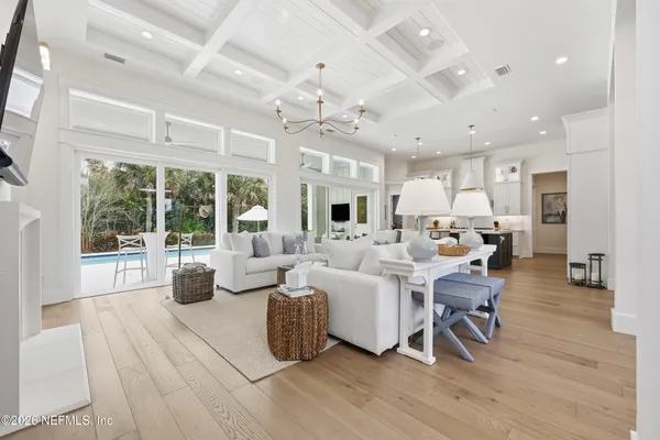 a kitchen with a dining table chairs sink and white cabinets