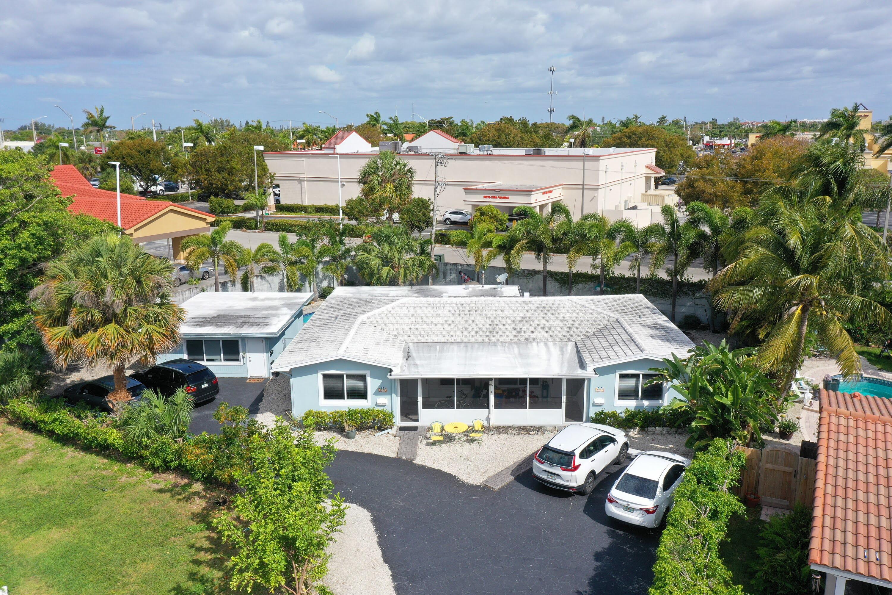 Undisclosed Address Lighthouse Point, FL 33064 - Photo 2 of 16 an aerial view of multiple houses with a yard