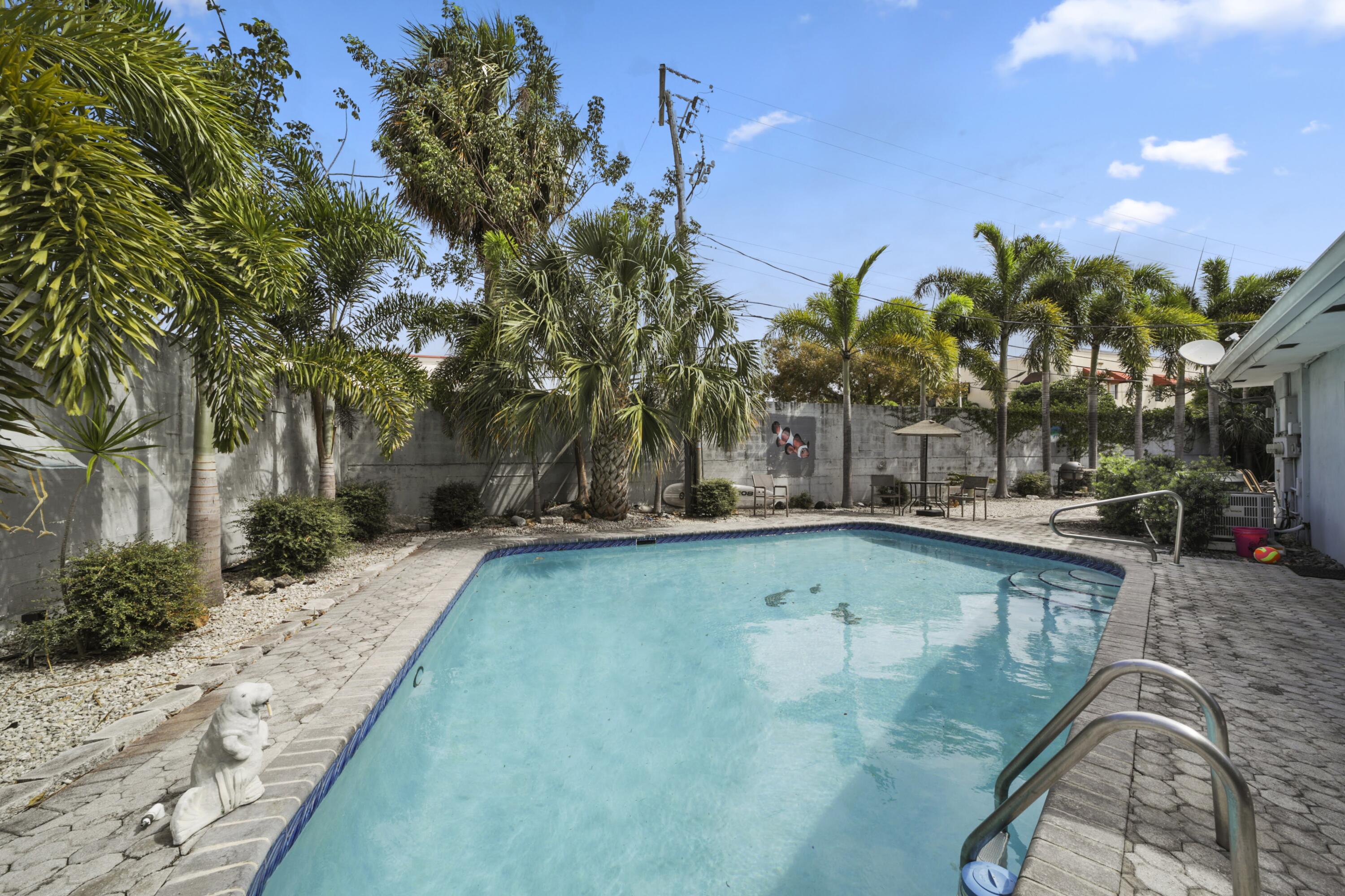 Undisclosed Address Lighthouse Point, FL 33064 - Photo 3 of 16 a view of a swimming pool with an outdoor space and seating area