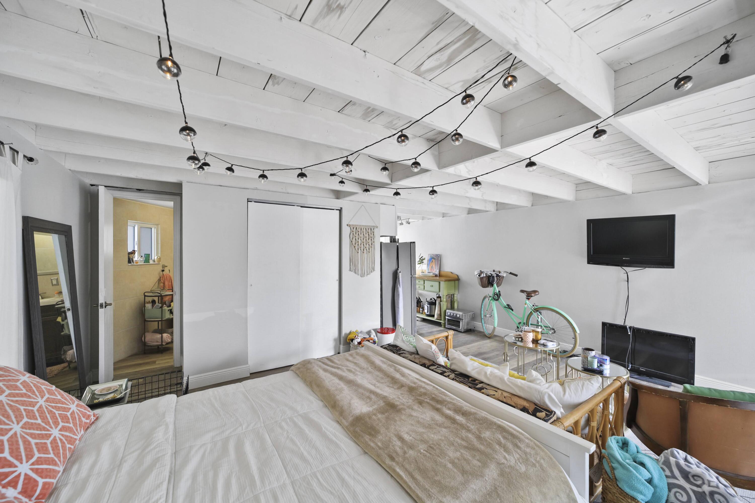 Undisclosed Address Lighthouse Point, FL 33064 - Photo 7 of 16 a bed room with a bed window and a flat screen tv
