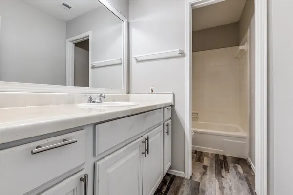 a bathroom with a sink a toilet and a tub