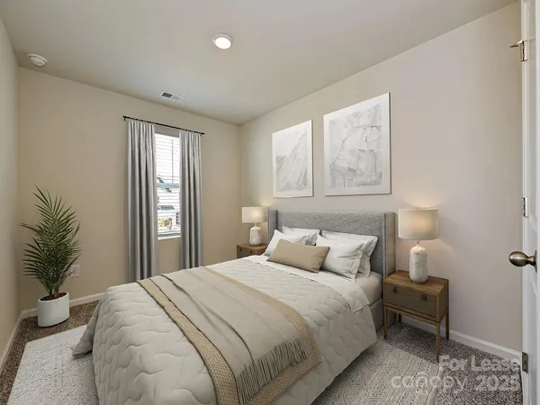 a bedroom with a large bed and a potted plant