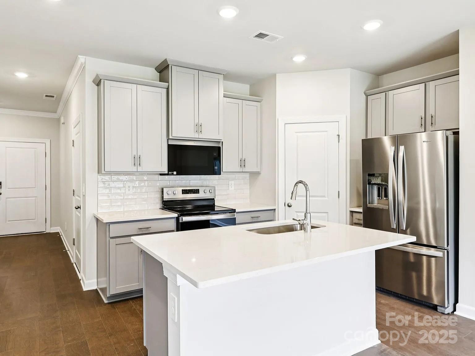 6122 Starview Terrace Charlotte, NC 28216 - Photo 4 of 19 a kitchen with stainless steel appliances a refrigerator stove microwave and sink