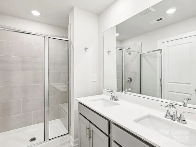a bathroom with a shower sink and mirror