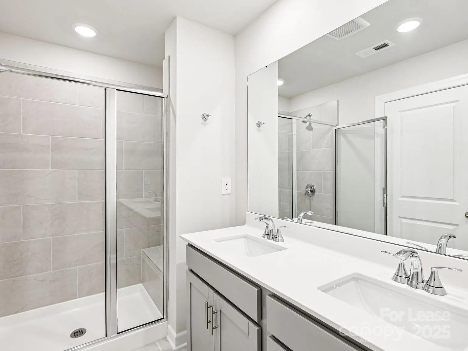 6122 Starview Terrace Charlotte, NC 28216 - Photo 7 of 19 a bathroom with a shower sink and mirror