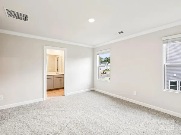 an empty room with windows and closet