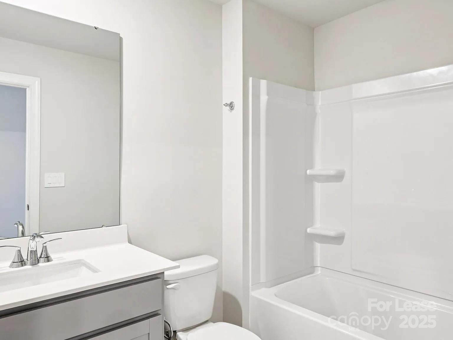 6122 Starview Terrace Charlotte, NC 28216 - Photo 10 of 19 a bathroom with a sink a toilet and shower