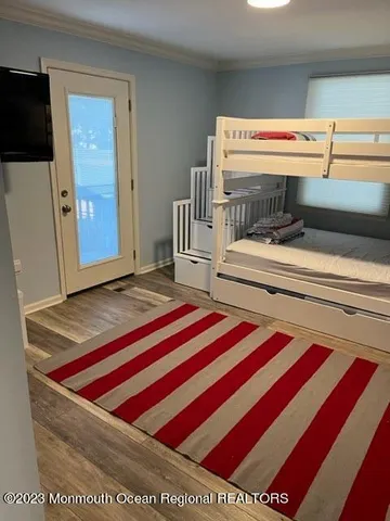 a bedroom with a bed and a television