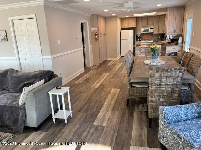 a kitchen with stainless steel appliances kitchen island granite countertop a refrigerator and a stove top oven