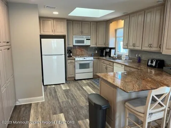 a kitchen with a refrigerator a sink and cabinets