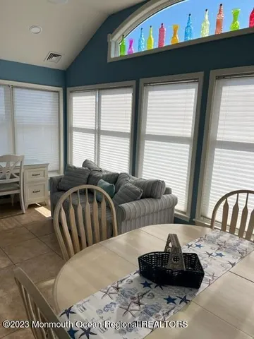 a living room with furniture fireplace and a window