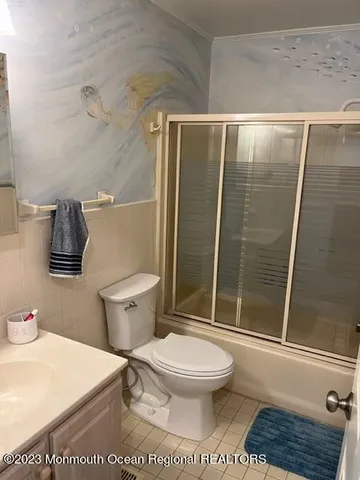 a white toilet sitting next to a bathroom sink and shower