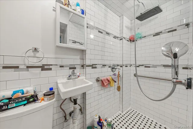 a bathroom with a sink mirror and toilet