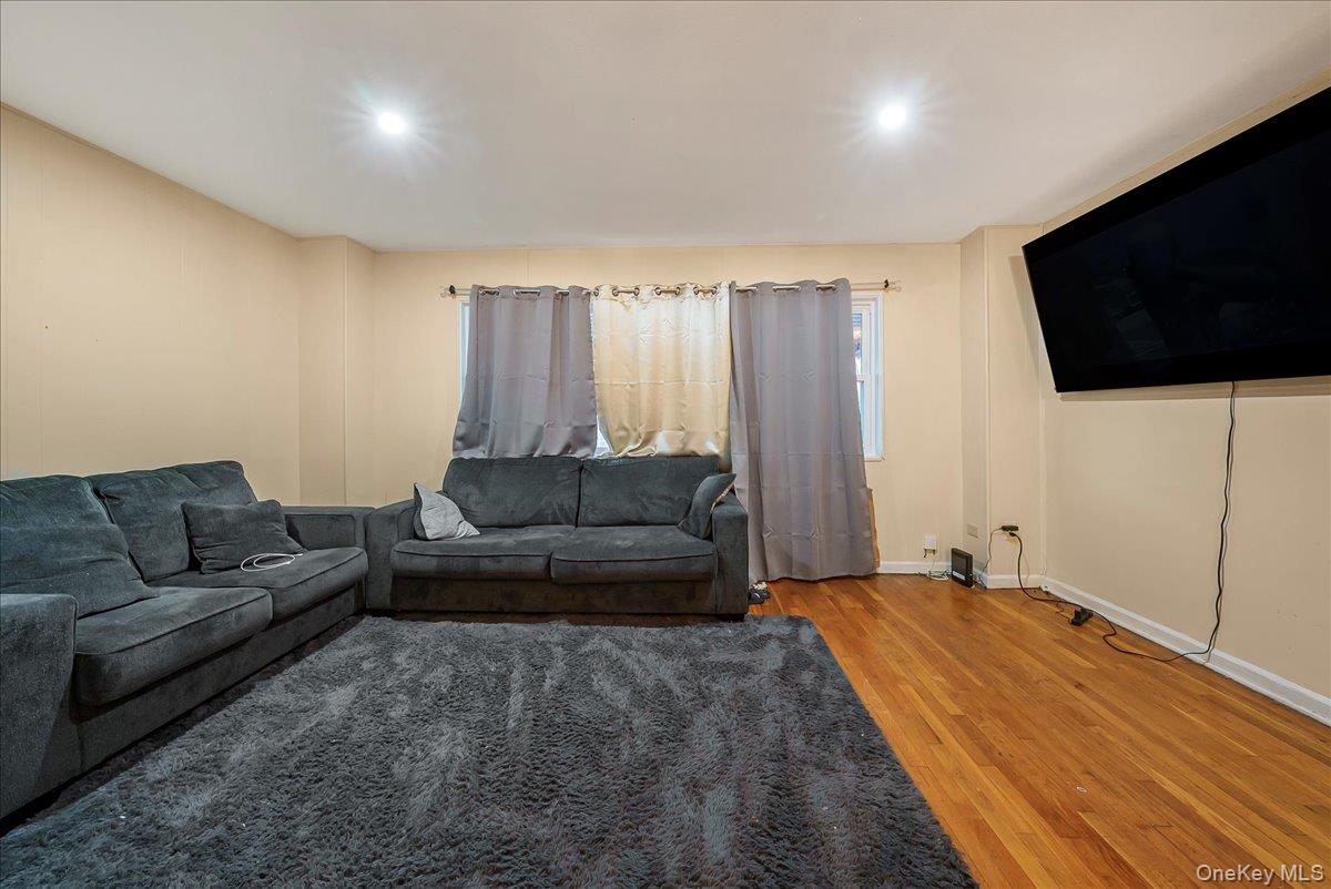 4183 Murdock Avenue Bronx, NY 10466 - Photo 12 of 22 a living room with furniture and a flat screen tv