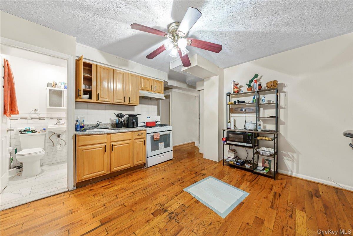 4183 Murdock Avenue Bronx, NY 10466 - Photo 14 of 22 a open kitchen with stainless steel appliances granite countertop a stove cabinets and wooden floor