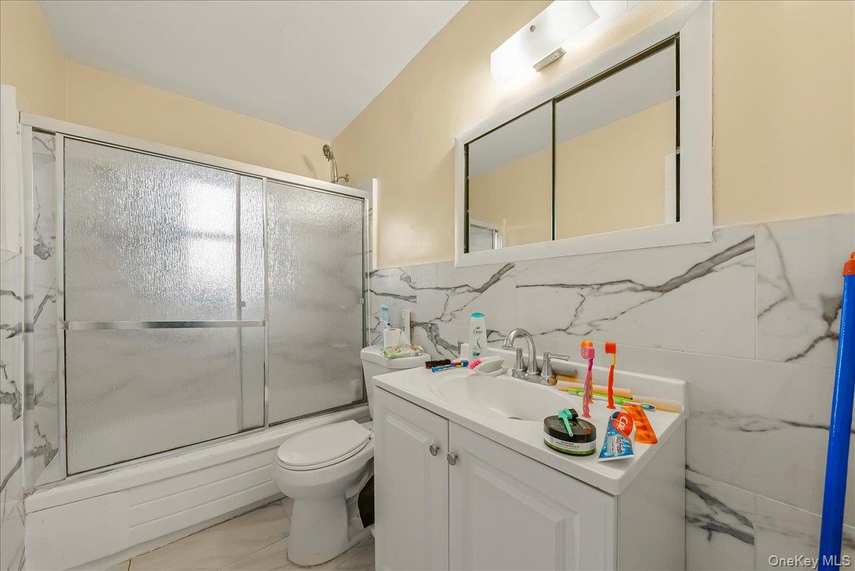 4183 Murdock Avenue Bronx, NY 10466 - Photo 4 of 22 a bathroom with a sink toilet and shower