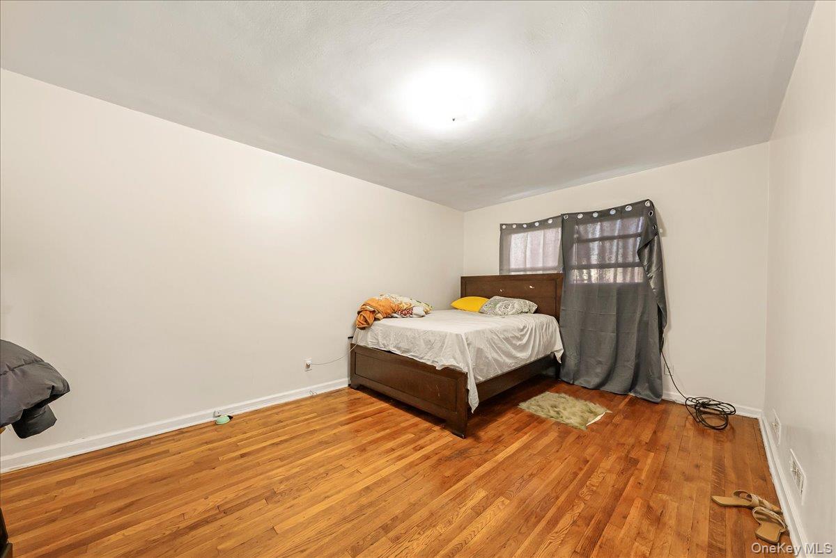 4183 Murdock Avenue Bronx, NY 10466 - Photo 6 of 22 a bedroom with a bed and wooden floor