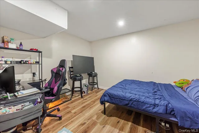 a bedroom with furniture and a flat screen tv