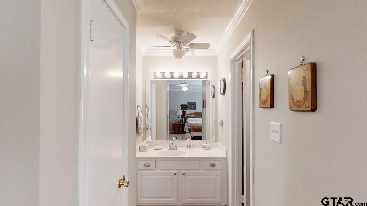 1202 Rice Road, Unit 143 Tyler, TX 75703 - Photo 16 of 27 a bathroom with a sink and mirror