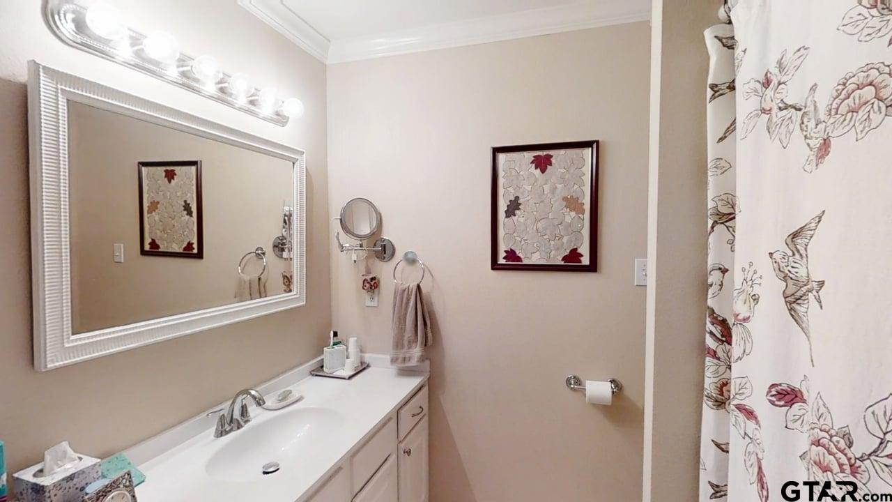 1202 Rice Road, Unit 143 Tyler, TX 75703 - Photo 21 of 27 a bathroom with a sink and a mirror