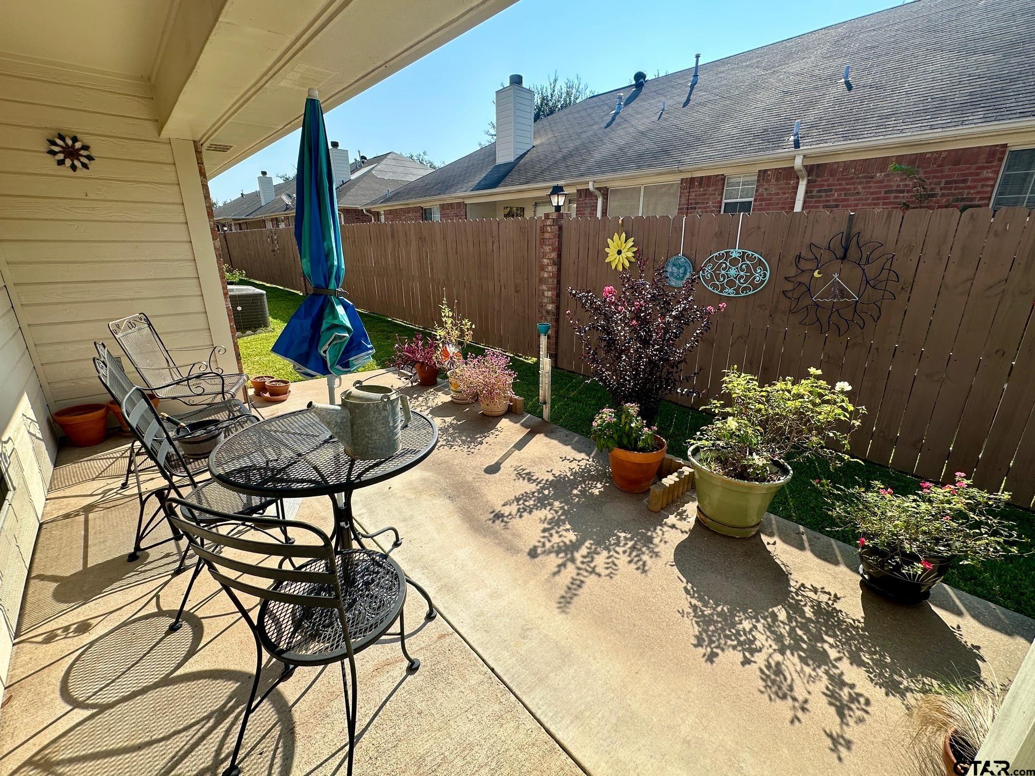 1202 Rice Road, Unit 143 Tyler, TX 75703 - Photo 24 of 27 a view of a chairs and table in a backyard