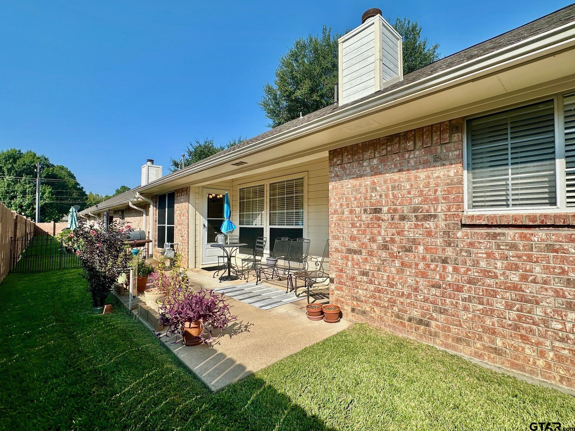 1202 Rice Road, Unit 143 Tyler, TX 75703 - Photo 26 of 27 a front view of a house with garden and porch