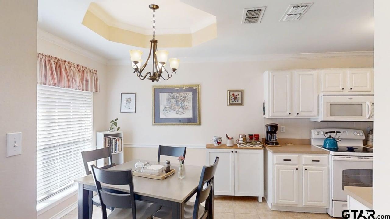 1202 Rice Road, Unit 143 Tyler, TX 75703 - Photo 8 of 27 a kitchen with white cabinets and white appliances