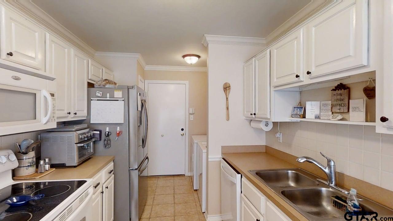 1202 Rice Road, Unit 143 Tyler, TX 75703 - Photo 10 of 27 a kitchen that has a sink cabinets counter space and appliances