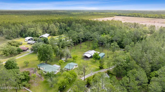 a large kitchen with stainless steel appliances granite countertop a stove a sink dishwasher and a refrigerator with wooden floor