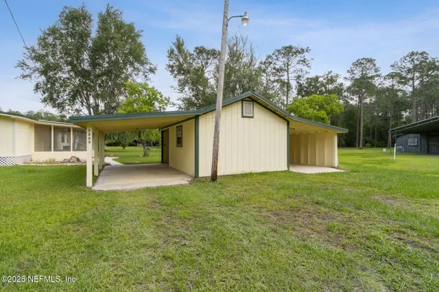 an empty room with a window and a ceiling fan
