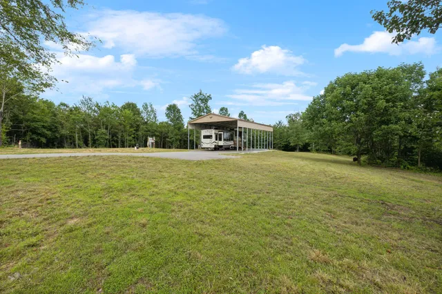 a view of a swimming pool with an outdoor seating and a yard