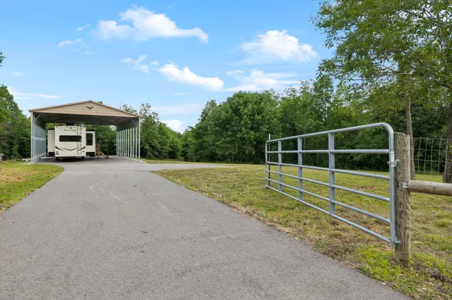 a view of a house with swimming pool and a yard