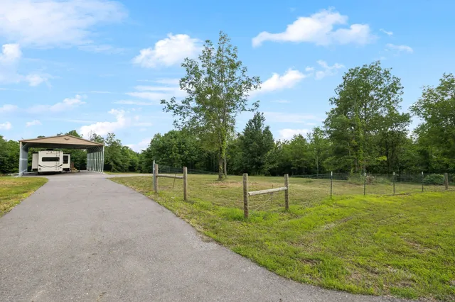 a view of a backyard with swimming pool