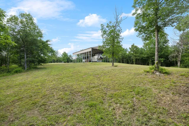 a view of a field with a trees in the background