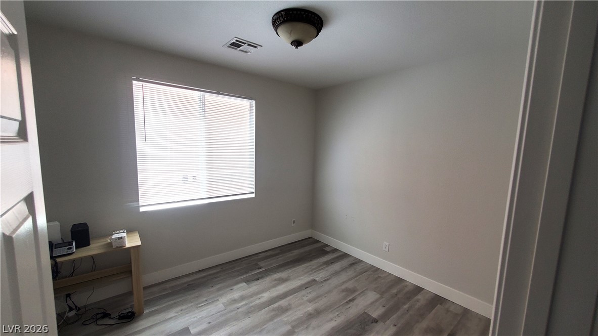 7903 Dell Ridge Avenue Las Vegas, NV 89179 - Photo 5 of 20 Well-lit room with durable wood-look flooring and a functional window for natural light.