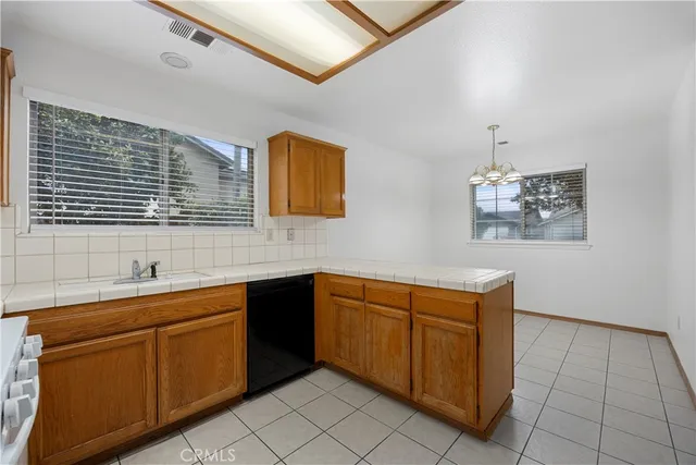 a kitchen with a sink stove and cabinets